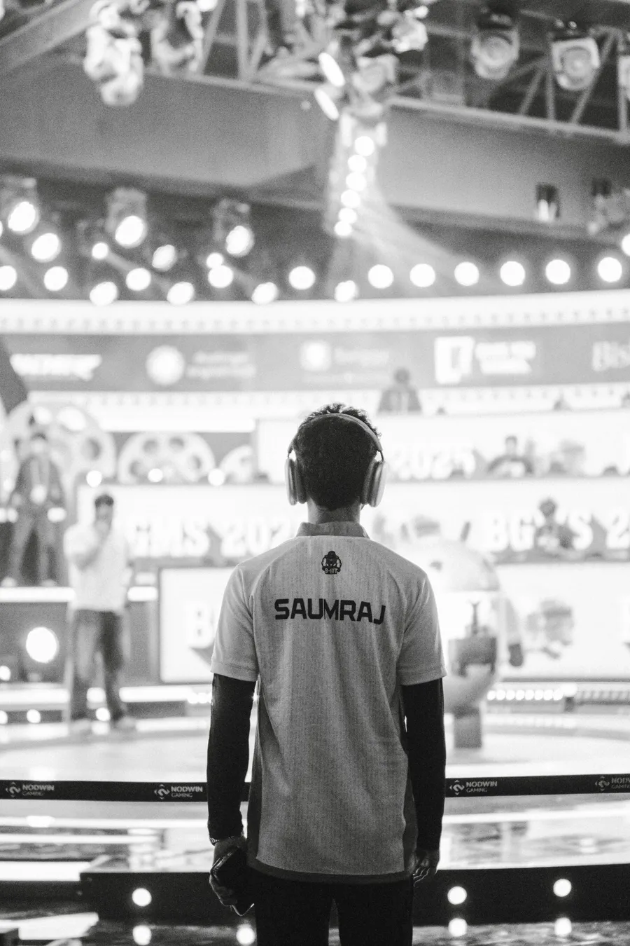 Professional gamer facing an esports stage during a competition